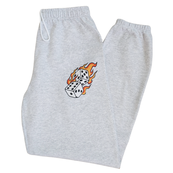 These Western tattoo-inspired sweatpants feature a bold flaming dice graphic on soft, cozy fleece—perfect for anyone who loves unique, edgy loungewear. Made with 50% cotton / 50% polyester, these unisex joggers have a naturally oversized fit for extra comfort. Designed with a drawstring elastic waistband, elastic cuffs, and no pockets for a clean, streamlined look. 