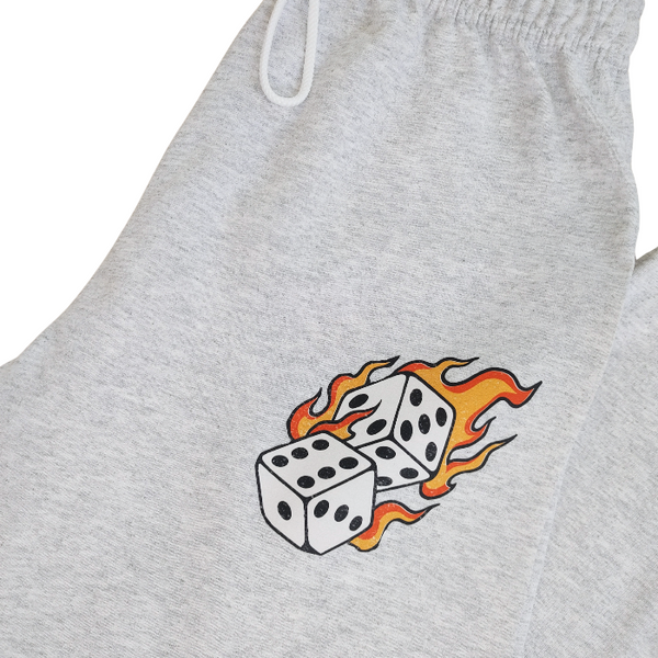These Western tattoo-inspired sweatpants feature a bold flaming dice graphic on soft, cozy fleece—perfect for anyone who loves unique, edgy loungewear. Made with 50% cotton / 50% polyester, these unisex joggers have a naturally oversized fit for extra comfort. Designed with a drawstring elastic waistband, elastic cuffs, and no pockets for a clean, streamlined look. 