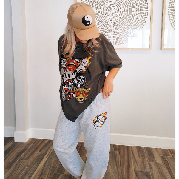 These Western tattoo-inspired sweatpants feature a bold flaming dice graphic on soft, cozy fleece—perfect for anyone who loves unique, edgy loungewear. Made with 50% cotton / 50% polyester, these unisex joggers have a naturally oversized fit for extra comfort. Designed with a drawstring elastic waistband, elastic cuffs, and no pockets for a clean, streamlined look. 