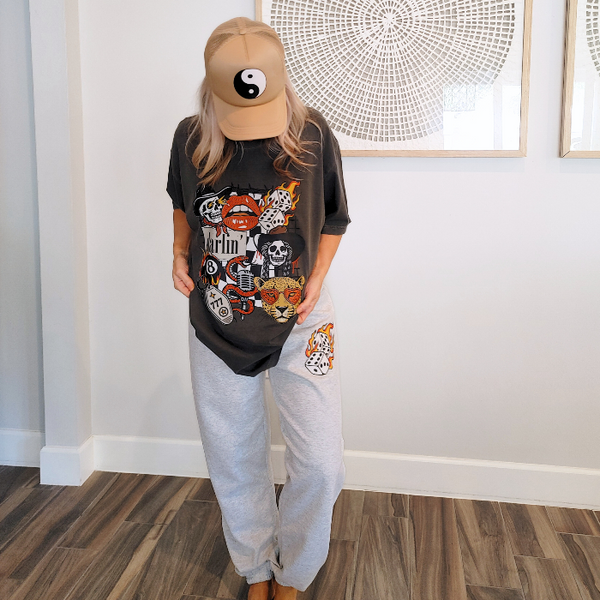 These Western tattoo-inspired sweatpants feature a bold flaming dice graphic on soft, cozy fleece—perfect for anyone who loves unique, edgy loungewear. Made with 50% cotton / 50% polyester, these unisex joggers have a naturally oversized fit for extra comfort. Designed with a drawstring elastic waistband, elastic cuffs, and no pockets for a clean, streamlined look. 