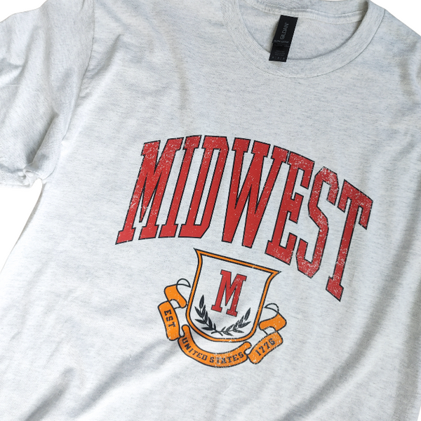 This Retro Midwest Graphic Tee brings classic collegiate style and effortless comfort together in one timeless design. Featuring a distressed varsity-inspired "Midwest" graphic on a soft 100% cotton Gildan unisex tee, it's perfect for anyone who loves vintage aesthetics, casual streetwear, and laid-back everyday fashion. Size up for a trendy oversized look.