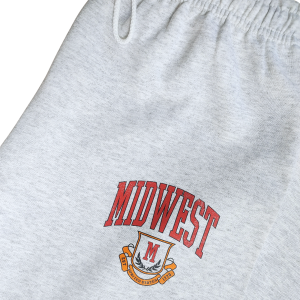 These Midwest Logo Sweatpants are the ultimate blend of comfort and casual oversized relaxed fit for a trendy streetwear look. Featuring a distressed varsity-inspired graphic that matches the sweatshirt and t-shirt in the collection, these ash gray joggers have a drawstring elastic waistband for adjustable comfort & are perfect for lounging, travel, errands, or creating a coordinated Midwest set look.