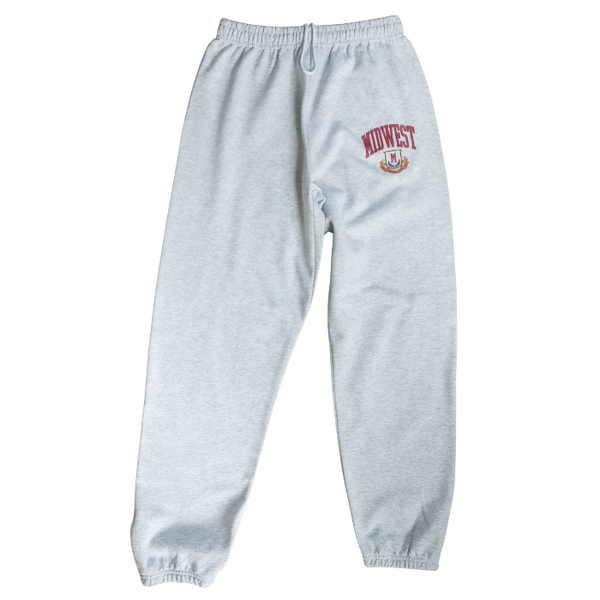 These Midwest Logo Sweatpants are the ultimate blend of comfort and casual oversized relaxed fit for a trendy streetwear look. Featuring a distressed varsity-inspired graphic that matches the sweatshirt and t-shirt in the collection, these ash gray joggers have a drawstring elastic waistband for adjustable comfort & are perfect for lounging, travel, errands, or creating a coordinated Midwest set look.