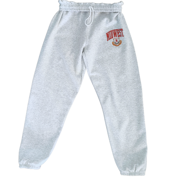 These Midwest Logo Sweatpants are the ultimate blend of comfort and casual oversized relaxed fit for a trendy streetwear look. Featuring a distressed varsity-inspired graphic that matches the sweatshirt and t-shirt in the collection, these ash gray joggers have a drawstring elastic waistband for adjustable comfort & are perfect for lounging, travel, errands, or creating a coordinated Midwest set look.
