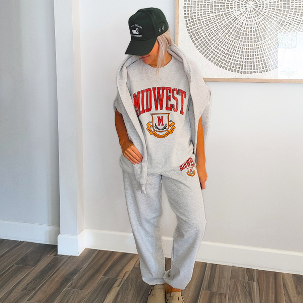 This Retro Midwest Graphic Tee brings classic collegiate style and effortless comfort together in one timeless design. Featuring a distressed varsity-inspired "Midwest" graphic on a soft 100% cotton Gildan unisex tee, it's perfect for anyone who loves vintage aesthetics, casual streetwear, and laid-back everyday fashion. Size up for a trendy oversized look.