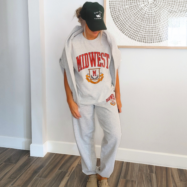 This Retro Midwest Graphic Tee brings classic collegiate style and effortless comfort together in one timeless design. Featuring a distressed varsity-inspired "Midwest" graphic on a soft 100% cotton Gildan unisex tee, it's perfect for anyone who loves vintage aesthetics, casual streetwear, and laid-back everyday fashion. Size up for a trendy oversized look.