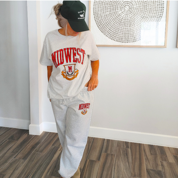 This Retro Midwest Graphic Tee brings classic collegiate style and effortless comfort together in one timeless design. Featuring a distressed varsity-inspired "Midwest" graphic on a soft 100% cotton Gildan unisex tee, it's perfect for anyone who loves vintage aesthetics, casual streetwear, and laid-back everyday fashion. Size up for a trendy oversized look.