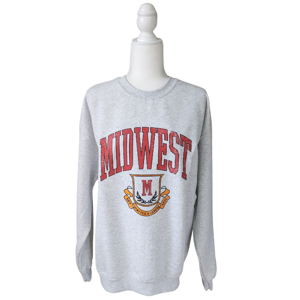 This Midwest Sweatshirt is the perfect blend of cozy comfort and classic collegiate style. Featuring a distressed varsity-inspired graphic on a soft ash gray crewneck, this unisex sweatshirt delivers an effortless retro look that's perfect for everyday wear, game days, travel, or lounging in comfort. Size up for an oversized sweatshirt look.
