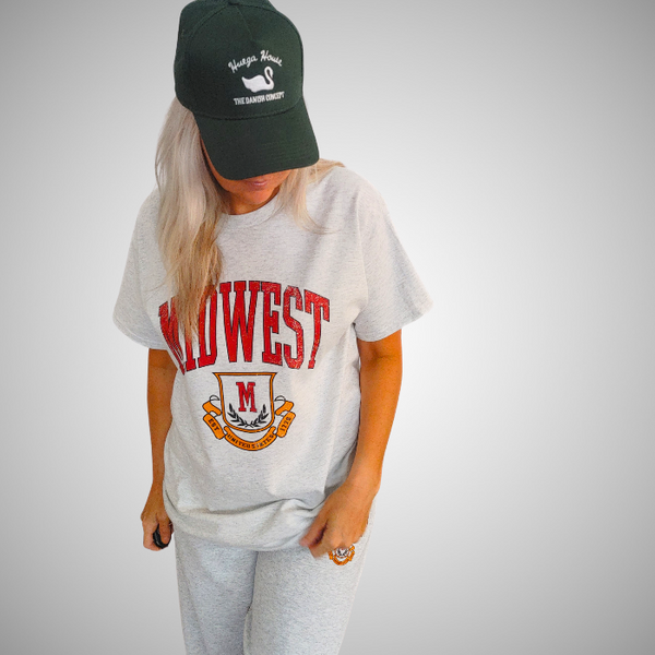This Retro Midwest Graphic Tee brings classic collegiate style and effortless comfort together in one timeless design. Featuring a distressed varsity-inspired "Midwest" graphic on a soft 100% cotton Gildan unisex tee, it's perfect for anyone who loves vintage aesthetics, casual streetwear, and laid-back everyday fashion. Size up for a trendy oversized look.