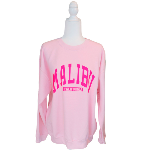 Our super soft pink Malibu crewneck is a great stylish and trendy piece. The Malibu California sweatshirt is perfect for layering or wearing alone for a casual look. With neon pink lettering, this sweatshirt is preppy in style and also makes the perfect gift! Don't forget to size up for an oversized trendy look.